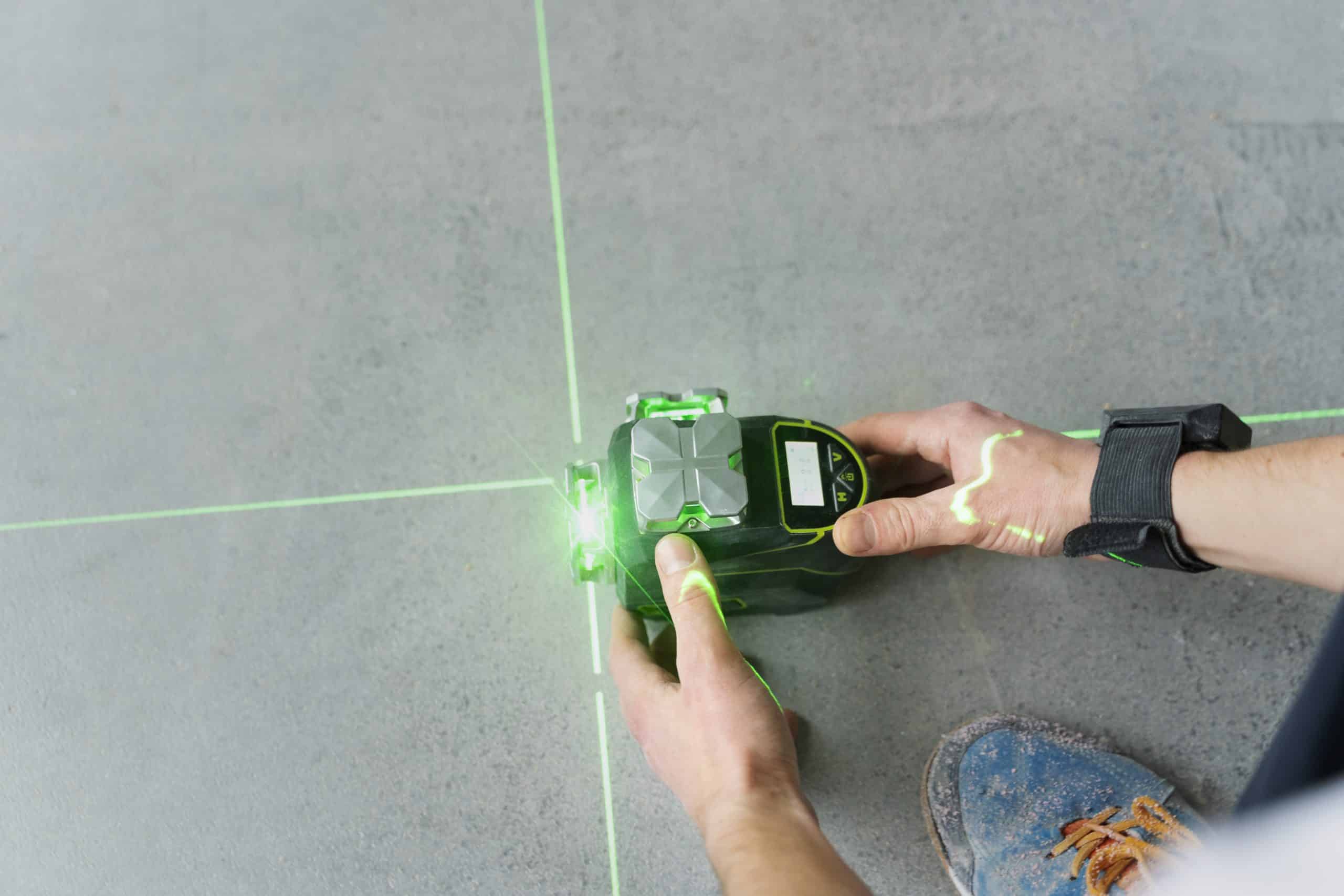 construction-worker-holding-tool-with-green-light